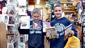 Levi Miller and brother, winner of the Book Buzz drawing, show off the books purchased with his $25 gift certificate.